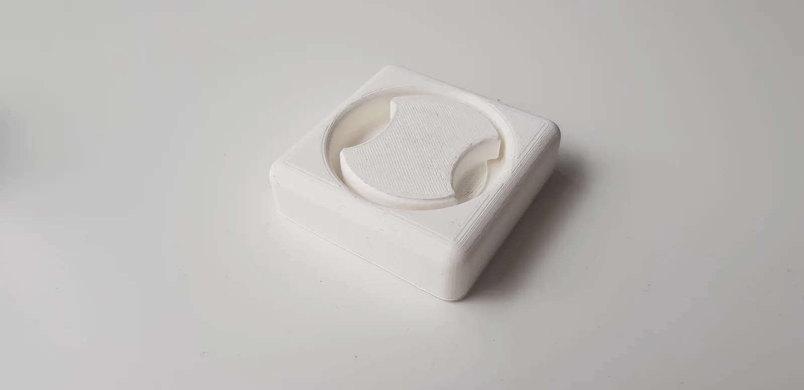 A photo of one of the 3D printed prototypes of the box, testing the screw top