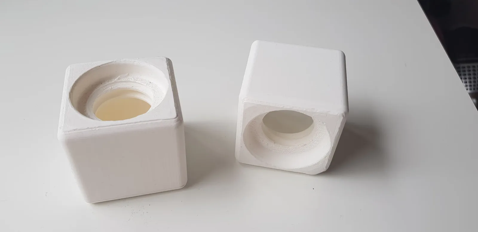 A photo of two of the 3D printed prototypes of the box, testing the screw type.