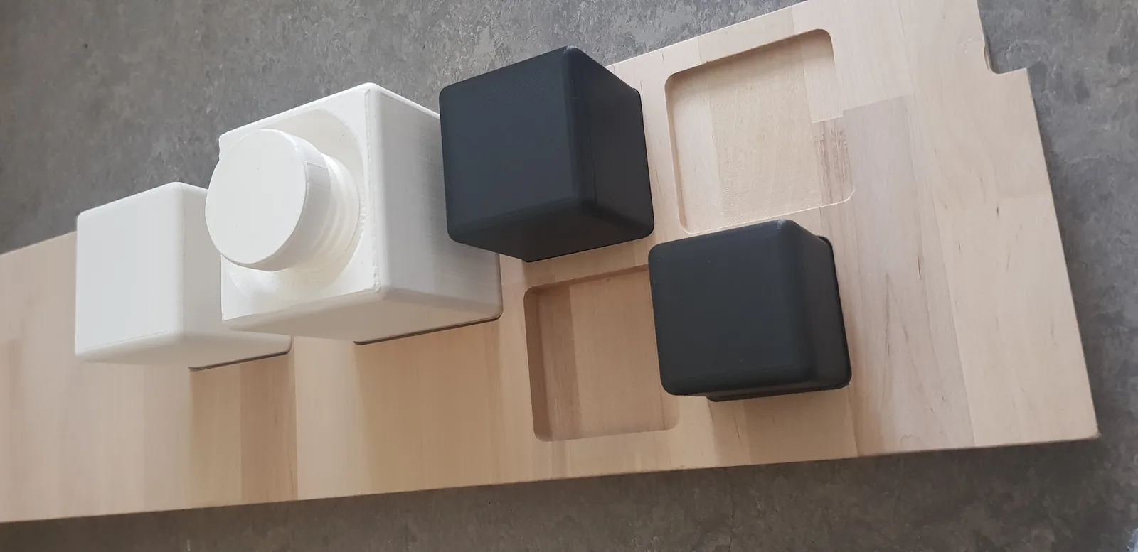 A photo of the four different box sizes together, visualizing their size difference on a wooden board