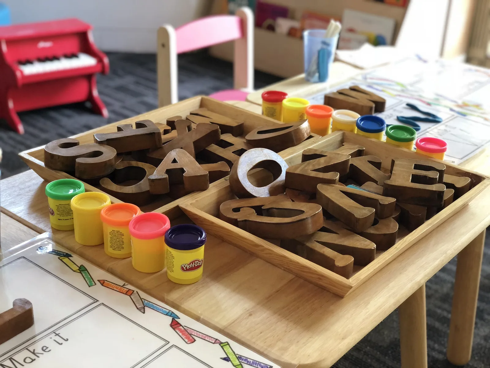 Photo of a table in a children's classroom with numbers and letter illustrating a form of activity both impaired and sighted children might enjoy.