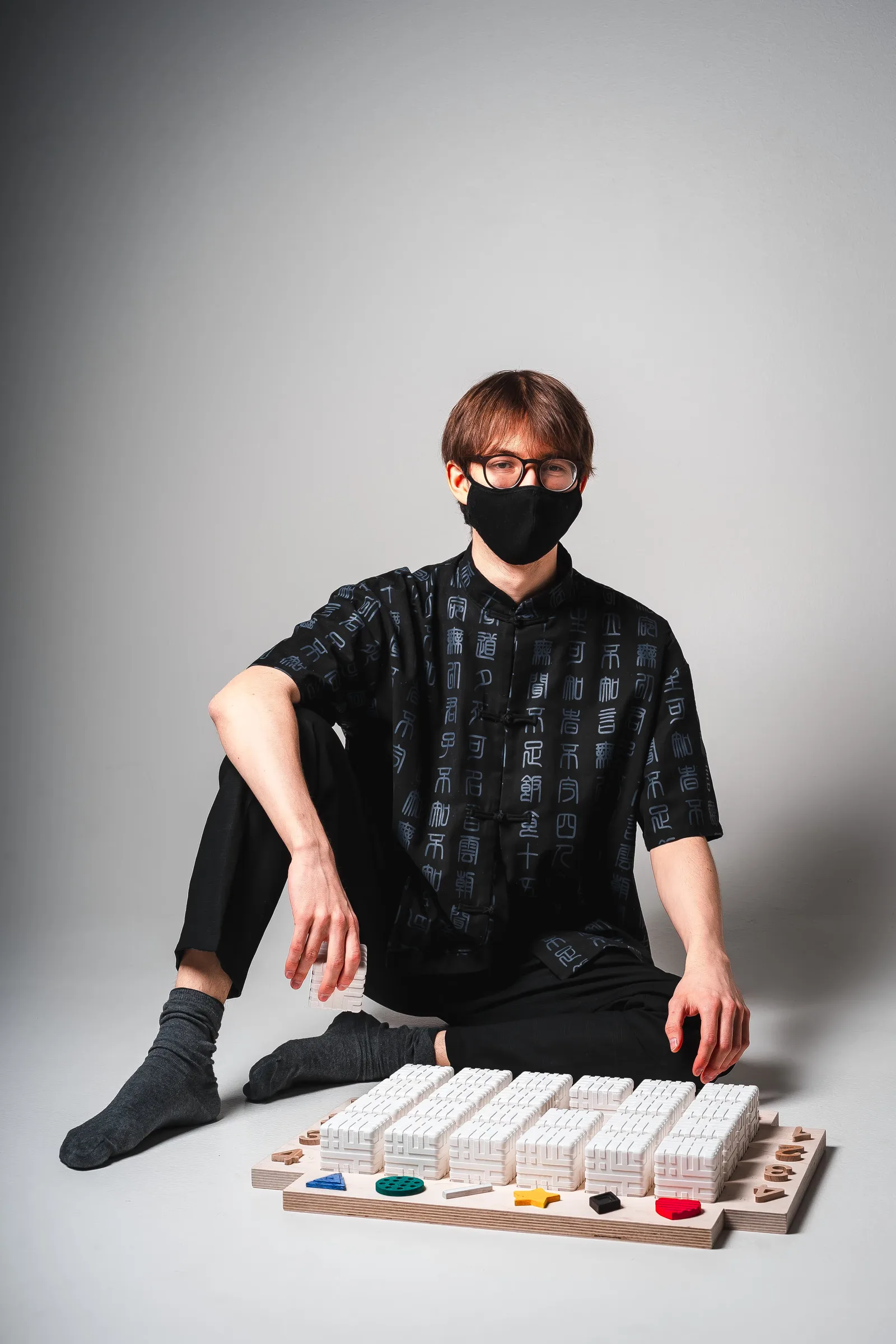 A photo of the final visually impaired board with its cubes and Radovan sitting next to it.