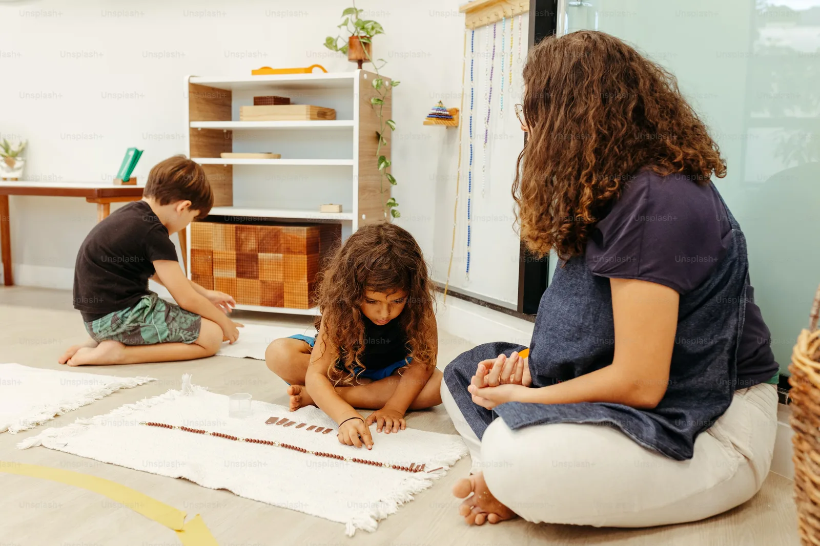 A photo of an impaired child playing by themselves in a classroom